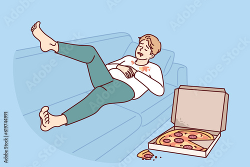 Ugly fat man sleeping on sofa near pizza box for wrong lifestyle concept of obesity causing. Guy suffering from problem of obesity needs help of nutritionist and eating healthy diet food.