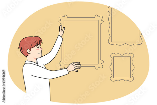 Man hanging frames with family pictures on wall. Happy male putting portrait for memory. Nostalgia concept. Home decoration. Vector illustration.