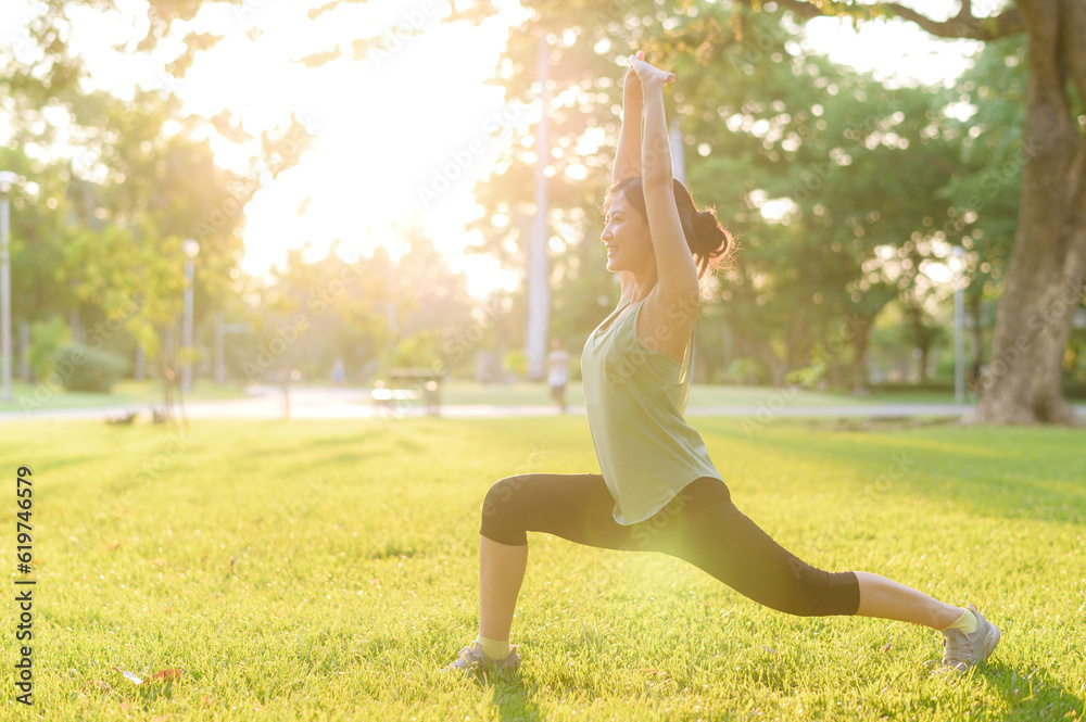 Female jogger. Fit young Asian woman with green sportswear stretching muscle in park before running and enjoying a healthy outdoor. Fitness runner girl in public park. Wellness being concept Female jogger. Fit young Asian woman with green sportswear stretching muscle in park before running and enjoying a healthy outdoor. Fitness runner girl in public park. Wellness being concept