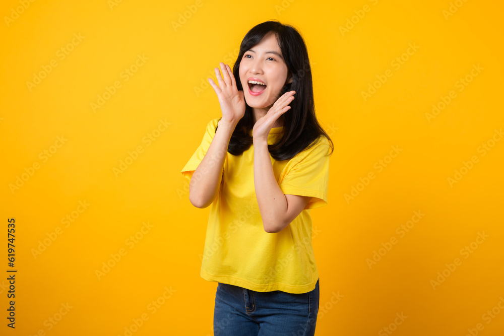 Portrait of a Young Asian Woman with Shout Hands Gesture Isolated on Yellow Studio Background Portrait of a Young Asian Woman with Shout Hands Gesture Isolated on Yellow Studio Background