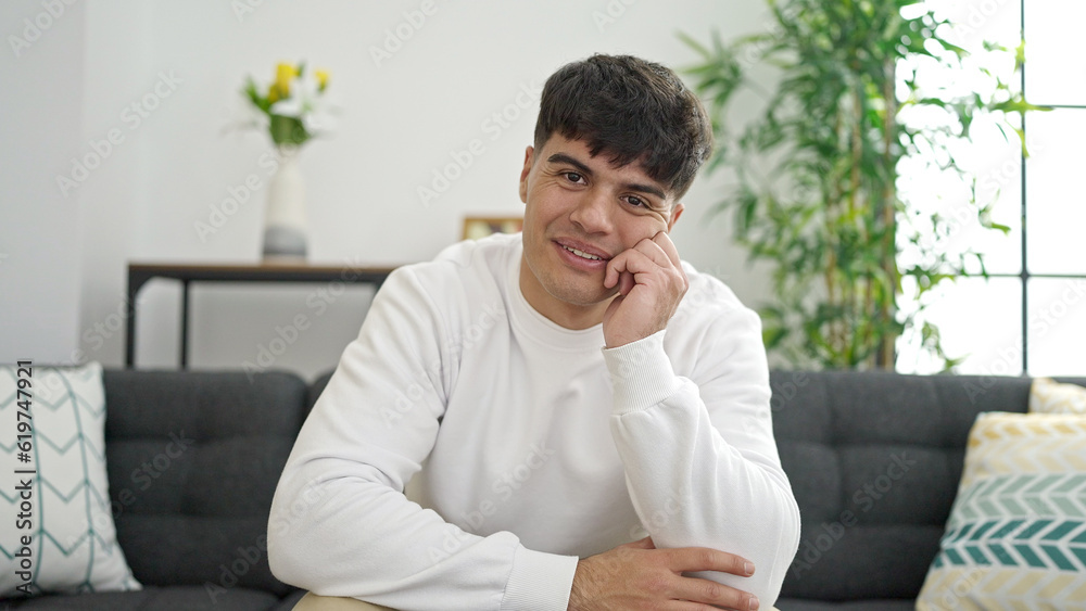Young hispanic man smiling confident sitting on sofa at home Young hispanic man smiling confident sitting on sofa at home
