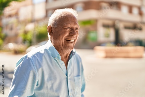 Senior grey-haired man smiling confident standing at street