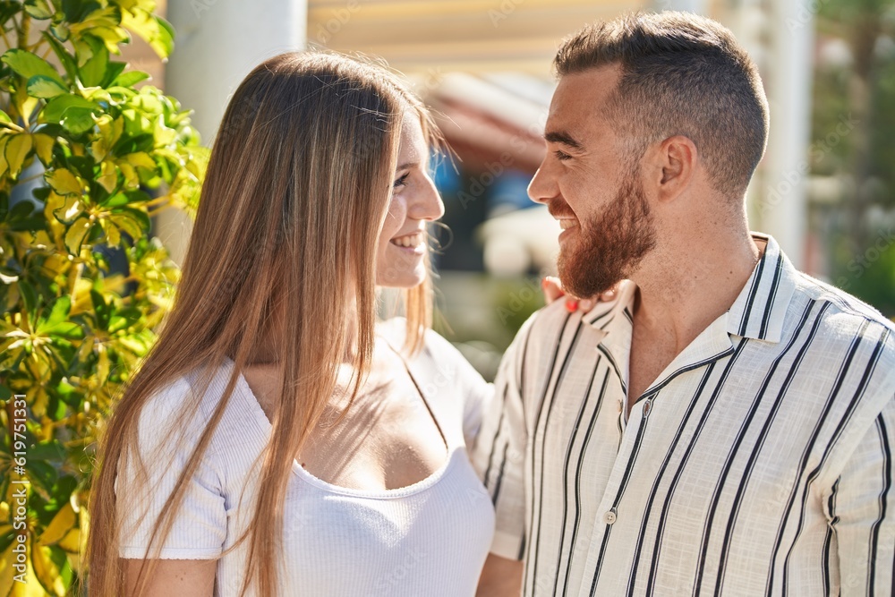 Man and woman couple smiling confident hugging each other at street
