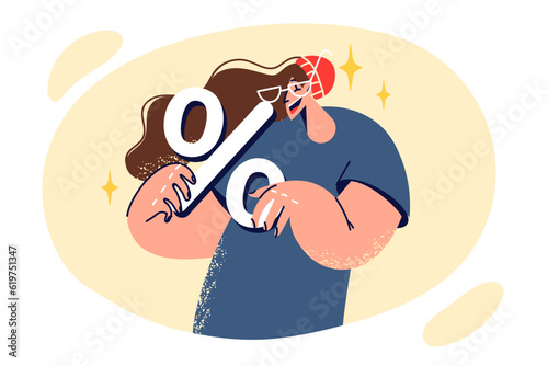 Woman holds percent sign symbolizing discounts on shopping and profitable promotions