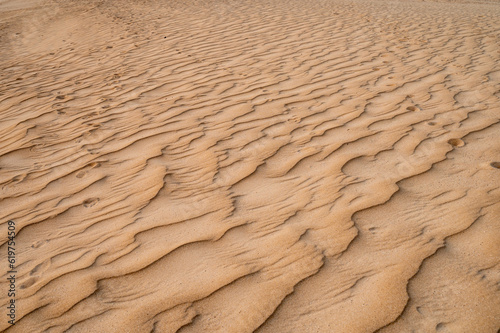 Dry sand during a hot summer day at the Dunes of Corralejo, Fuerteventura, Canary Islands, creating patterns and desert landscape