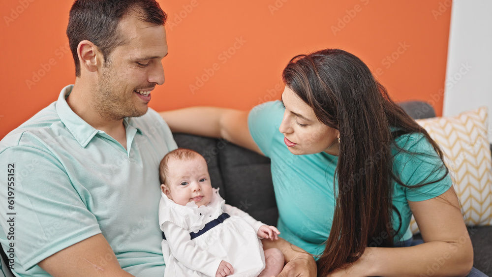 Family of three bonding sitting on the sofa at home Family of three bonding sitting on the sofa at home