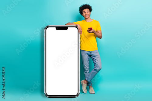 Full size photo of handsome person hold use smart phone huge empty space screen menu ui isolated on teal color background