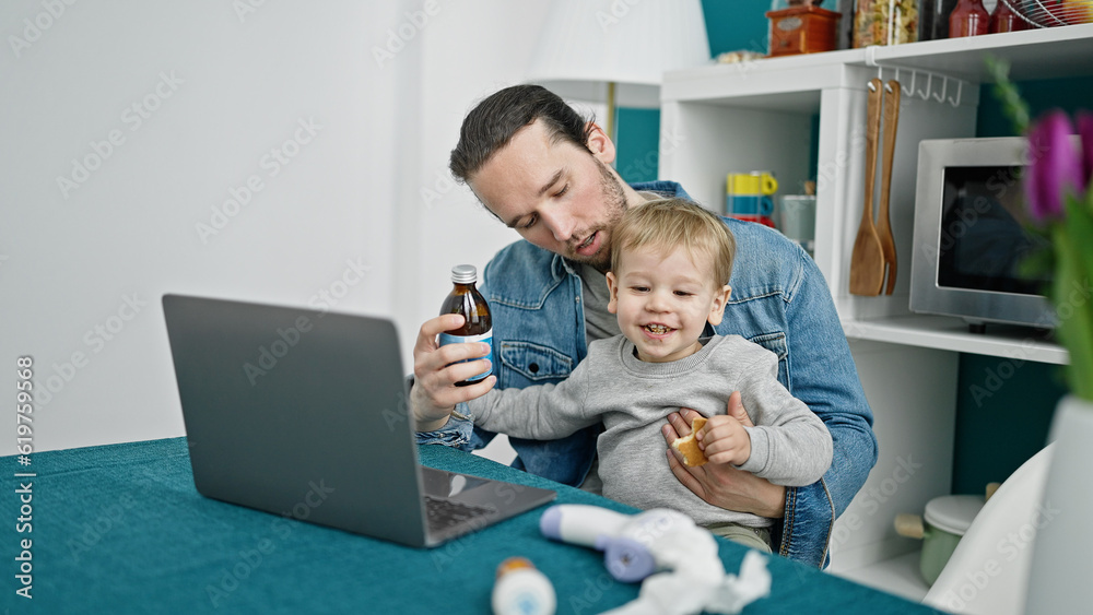 Father and son using laptop having online medical consultation at dinning room Father and son using laptop having online medical consultation at dinning room