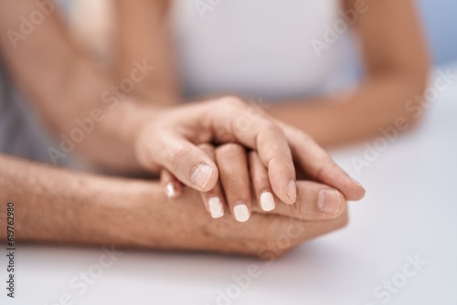 Man and woman with hands together at home