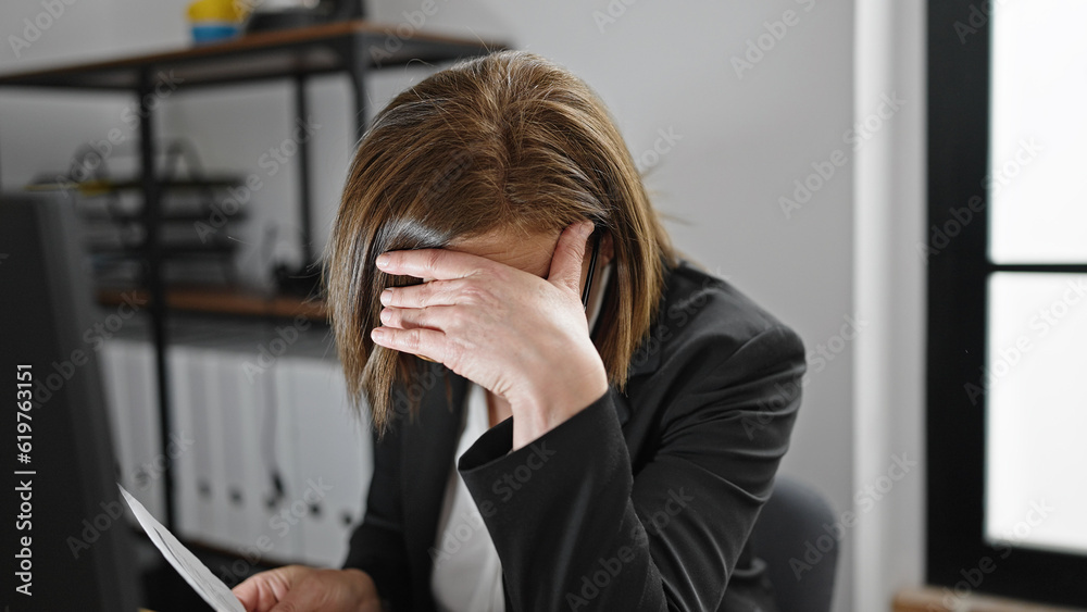 Middle age hispanic woman business worker stressed using computer at office Middle age hispanic woman business worker stressed using computer at office