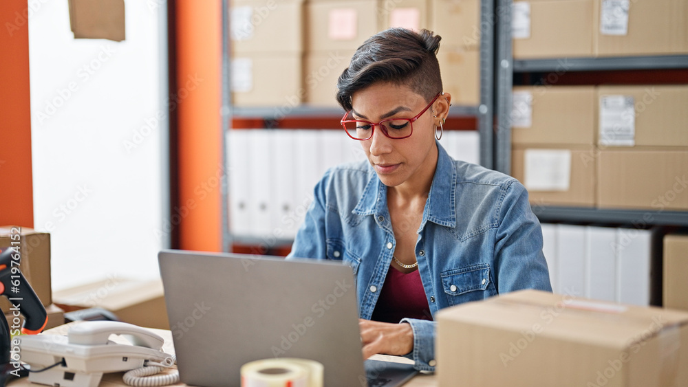 Young beautiful hispanic woman ecommerce business worker using laptop at office Young beautiful hispanic woman ecommerce business worker using laptop at office