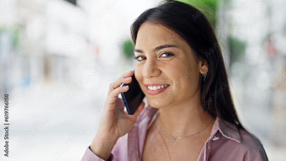 Young beautiful hispanic woman smiling confident talking on the smartphone at street Young beautiful hispanic woman smiling confident talking on the smartphone at street