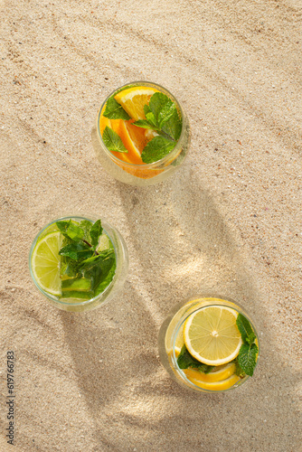 Mojito cocktail with citrus lime, lemon and orange on the beach