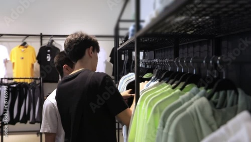 Guys in a stock store choosing clothes