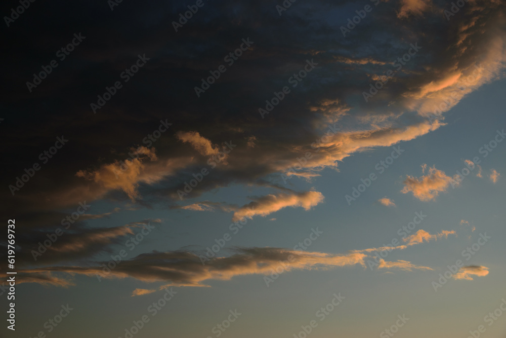 Sunset sky with orange clouds. Nature background.