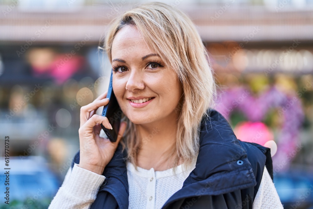 Young blonde woman smiling confident talking on the smartphone at street Young blonde woman smiling confident talking on the smartphone at street