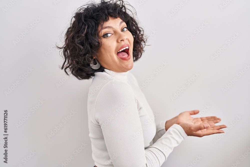 Hispanic woman with curly hair standing over isolated background pointing aside with hands open palms showing copy space, presenting advertisement smiling excited happy Hispanic woman with curly hair standing over isolated background pointing aside with hands open palms showing copy space, presenting advertisement smiling excited happy