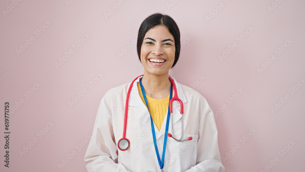 Young beautiful hispanic woman doctor smiling confident standing over isolated pink background Young beautiful hispanic woman doctor smiling confident standing over isolated pink background