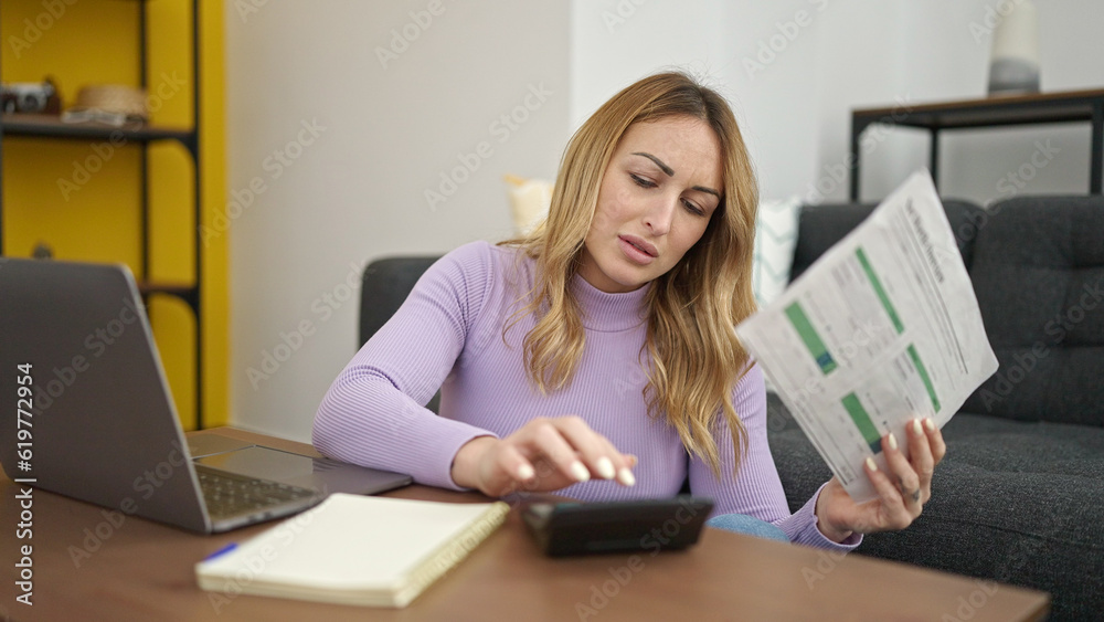 Young beautiful hispanic woman using laptop doing accounting at home Young beautiful hispanic woman using laptop doing accounting at home