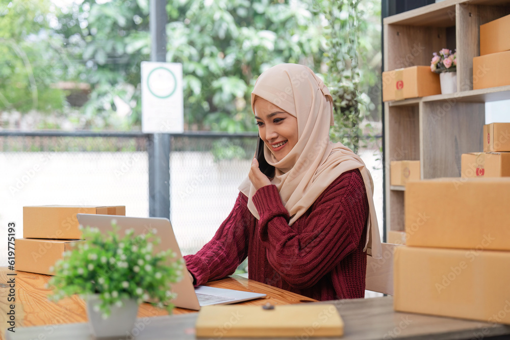 Beautiful Muslim woman selling online at home, business owner, business sme concepts