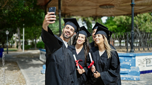 Group of people students graduated holding diploma make selfie by smartphone at university campus