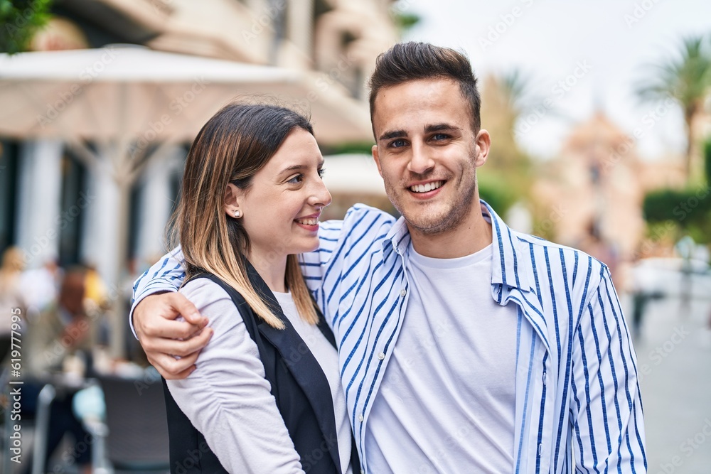 Man and woman couple smiling confident hugging each other at street Man and woman couple smiling confident hugging each other at street