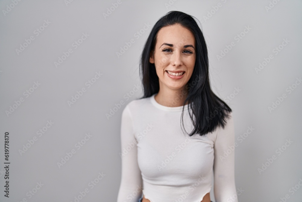 Hispanic woman standing over isolated background with a happy and cool smile on face. lucky person. Hispanic woman standing over isolated background with a happy and cool smile on face. lucky person.