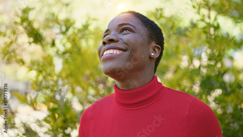African american woman smiling confident looking to the sky at park