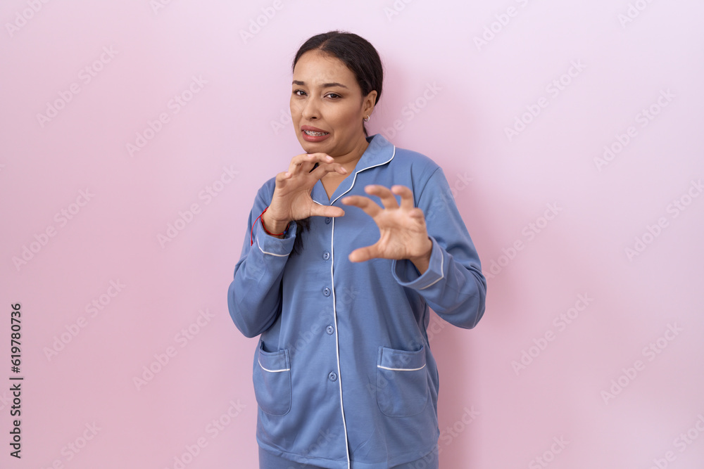 Young arab woman wearing blue pajama disgusted expression, displeased and fearful doing disgust face because aversion reaction. Young arab woman wearing blue pajama disgusted expression, displeased and fearful doing disgust face because aversion reaction.