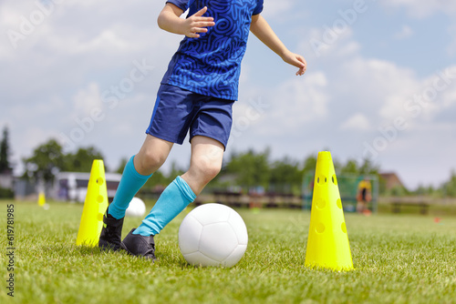 Obraz na plátně Young Boy on Soccer Training Slalom Drill