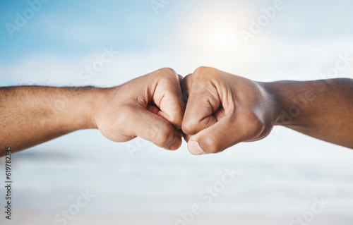 Man, hands and fist bump for partnership, unity or collaboration in deal or agreement outdoors. Hand of men or friends bumping fists for community, mission or goals together in solidarity or success © Wesley JvR/peopleimages.com