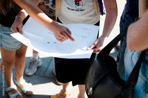 children examine and discuss the drawn map, children's outdoor games