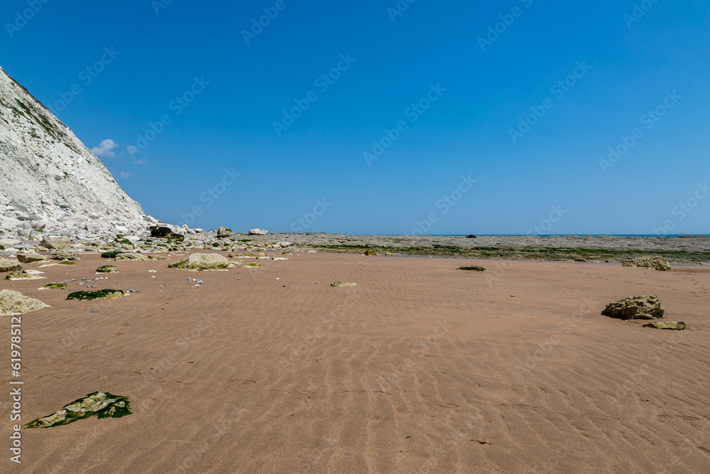 Looking along the beach between Eastbourne and Beachy Head at low tide, on a sunny summer's day