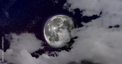 Composition of clouds and full moon on night sky