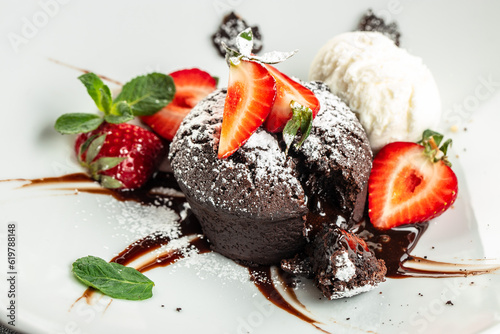 Chocolate fondant lava cake with strawberries. Restaurant menu, dieting, cookbook recipe top view