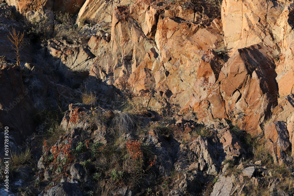 Layered rocks and hills. Surface of a natural stone brown colour Layered rocks and hills. Surface of a natural stone brown colour