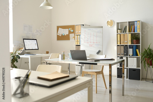 Modern office with workplaces with computers and flipchart for presentation © Mediaphotos