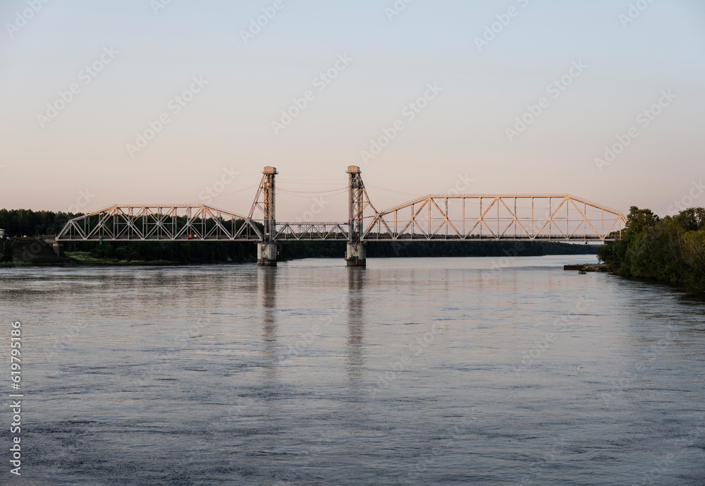 golden bridge over the river at sunset