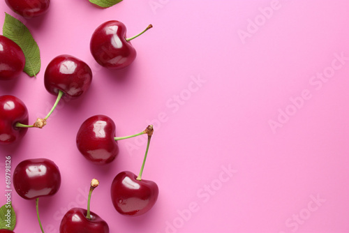 Cherry pattern. Flat lay of cherries on a pink background, Top view