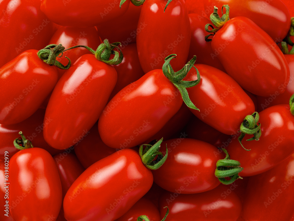 Raw Ornela cherry tomatoes macro background. Texture of small bottle shaped tomatoes. Ripe organic vegetables closeup. Healthy eating vegetarian food ingredient. Harvest concept. Raw Ornela cherry tomatoes macro background. Texture of small bottle shaped tomatoes. Ripe organic vegetables closeup. Healthy eating vegetarian food ingredient. Harvest concept.