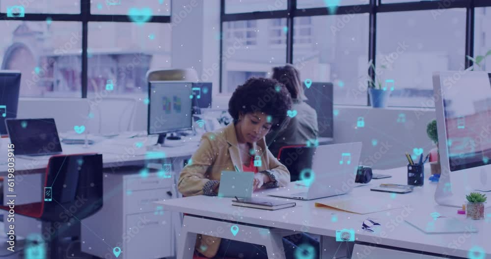Animation of network of digital icons over diverse man passing a document to a woman at office Animation of network of digital icons over diverse man passing a document to a woman at office