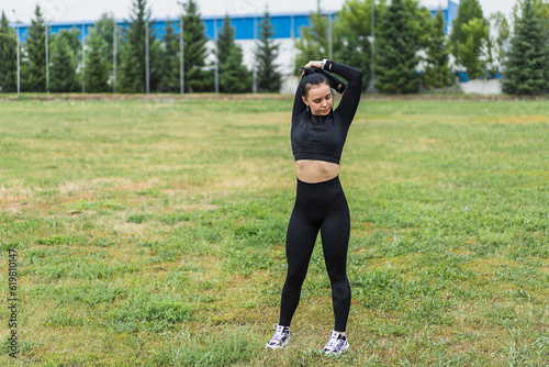 A young athlete stretches and prepares for a run in the open air. the concept of a healthy lifestyle