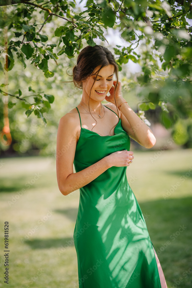 Charming woman wearing beautiful white dress under the apple tree Charming woman wearing beautiful white dress under the apple tree