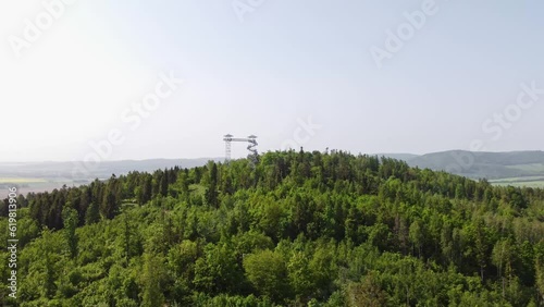 Aerial view of the two-towered lookout tower Hranicni vrch in the east of the Czech Republic. A reinforced concrete lookout tower at the top of the hill. 4k video photo