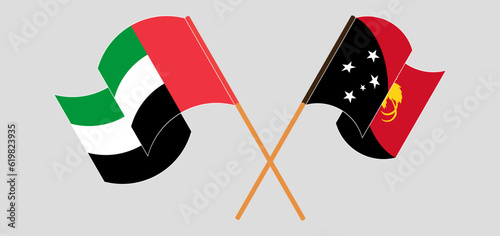 Crossed and waving flags of the United Arab Emirates and Papua New Guinea