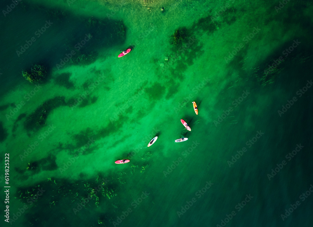 Aerial view group of people at Sup board at lake Kapchagay Aerial view group of people at Sup board at lake Kapchagay
