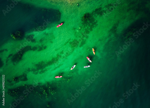 Aerial view group of people at Sup board at lake Kapchagay