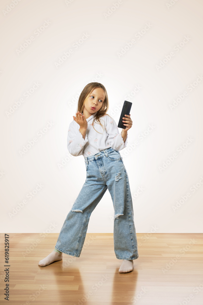 Preteen girl with smartphone chatting with friends. people, children ...