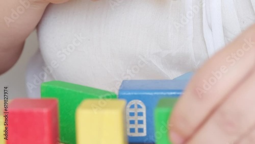 disabled elderly woman 55s hands plays wooden geometric figures, blocks, fine motor skills training, manual dexterity, exercises developing brain, prevention dementia and alzheimer's disease, support photo