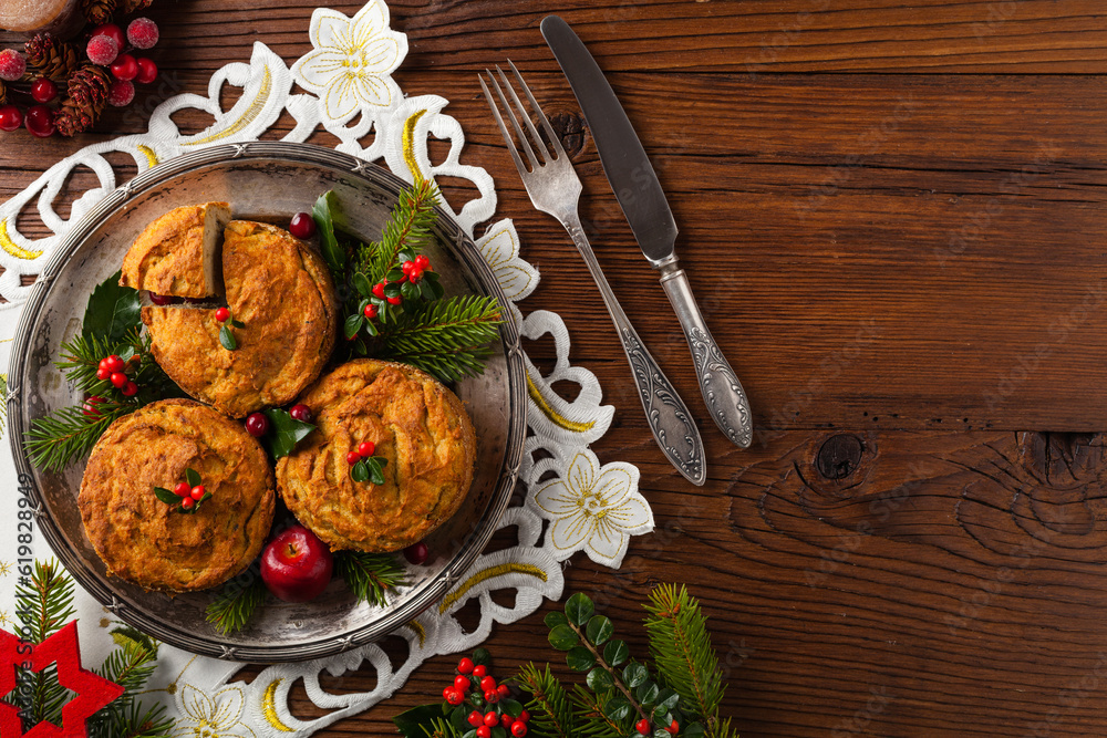 Small, baked patties in Christmas retro styling. Top view. Natural wooden background. Small, baked patties in Christmas retro styling. Top view. Natural wooden background.